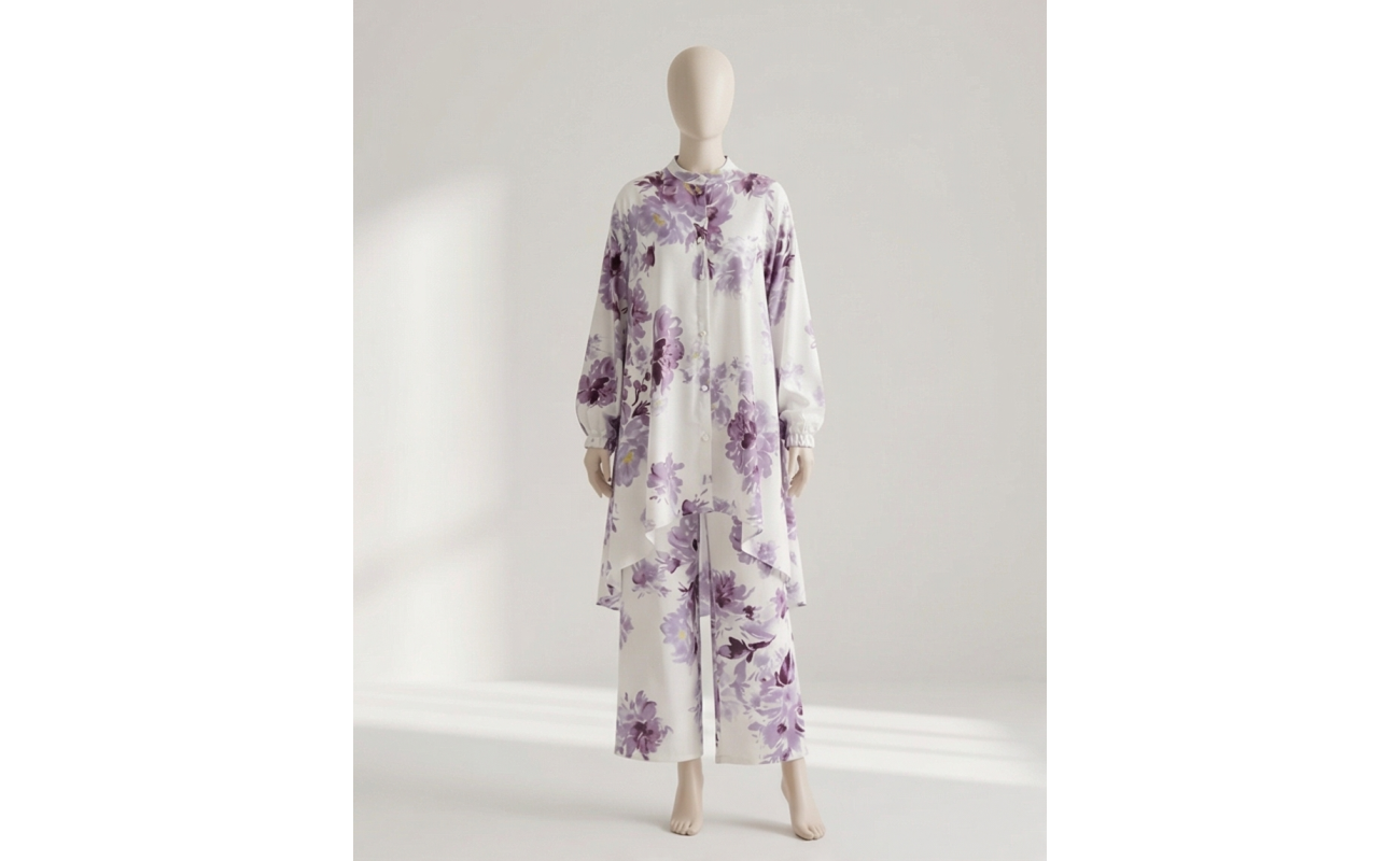 Mannequin wearing a white and purple floral Irish linen co-ord set with a long-line button-down shirt and matching wide-leg pants.