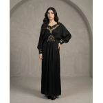 Woman modeling a luxurious black cotton lava kaftan dress featuring gold embroidery on the neck, waist, and cuffs.