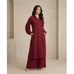 Woman walking in a minimalist corridor wearing a rich burgundy sheesha georgette co-ord set with a long tunic and wide-leg trousers.