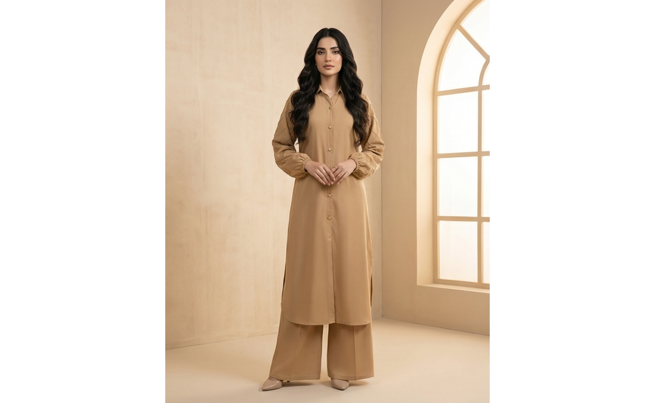 A woman modeling a camel-colored sheesha georgette co-ord set featuring a long tunic with quilted sleeves and matching wide-leg trousers.