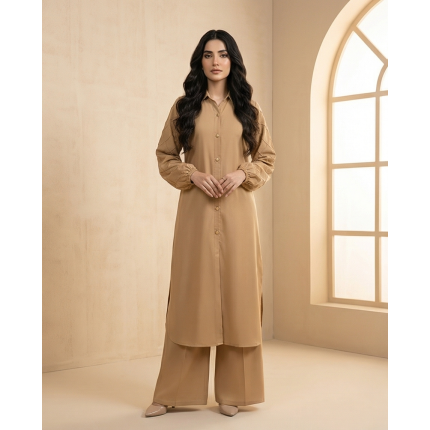 A woman modeling a camel-colored sheesha georgette co-ord set featuring a long tunic with quilted sleeves and matching wide-leg trousers.