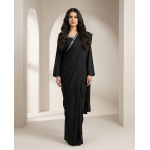 Woman modeling a stunning black shamooz silk sari with delicate silver embellishments along the border.
