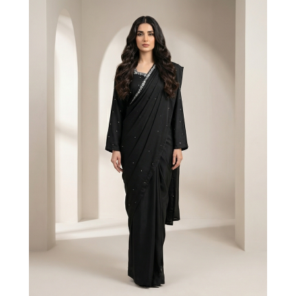 Woman modeling a stunning black shamooz silk sari with delicate silver embellishments along the border.