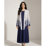 Woman wearing a navy blue cotton jersey maxi dress with a white shrug overlay featuring navy polka dots and floral patterns.