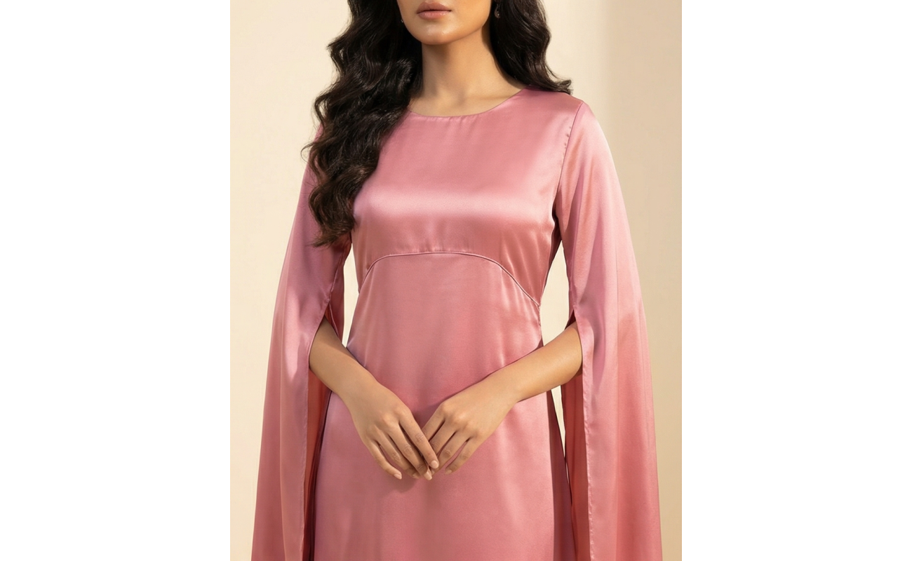 Woman wearing a romantic rosewood-colored shamoos silk maxi dress with long split-sleeve cape details and a modest boat neckline.