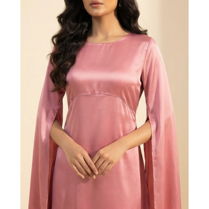 Woman wearing a romantic rosewood-colored shamoos silk maxi dress with long split-sleeve cape details and a modest boat neckline.