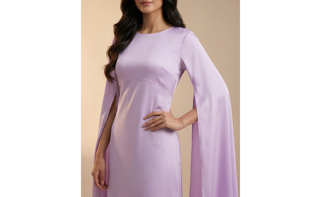 Woman wearing a dreamy lavender shamoos silk maxi dress with long split-sleeve cape details and a sophisticated boat neckline.