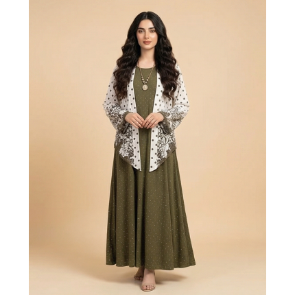 Woman modeling an olive green cotton jersey maxi dress with a white printed shrug featuring green floral and polka dot patterns.