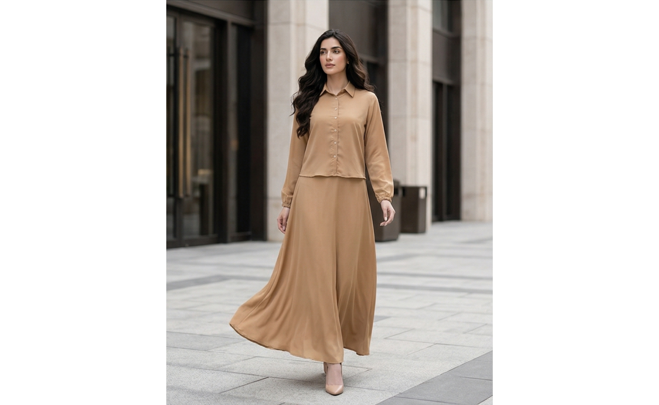 Woman wearing a long-sleeve camel-colored georgette maxi dress with a button-down collar and flowing floor-length skirt.