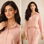 Woman wearing a peach-colored Irish linen co-ord set with a subtle floral print and button-up long-sleeve shirt.